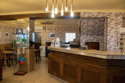 a restaurant with a bar and a dining room at Hostal Caminito del Rey in Alora