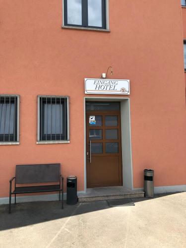 a bench sitting in front of a building at Hotel Stadt-Lindau in Neu-Ulm