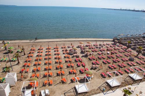 an aerial view of a beach with chairs and tables at Royal G Hotel and Spa in Durrës