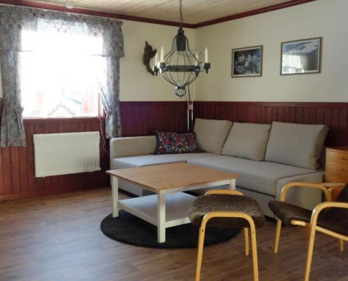 a living room with a couch and a table at Funäsdalens Stugby in Funäsdalen
