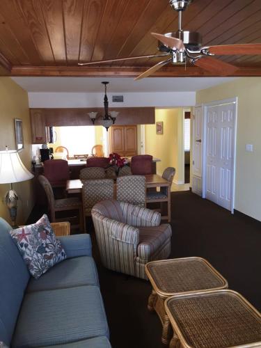 a living room with a couch and a dining room at GetAways at Soundside Holiday Beach Resort in Pensacola Beach