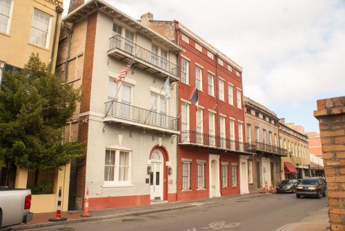 a building with an american flag on it on a street at Grenoble House in New Orleans