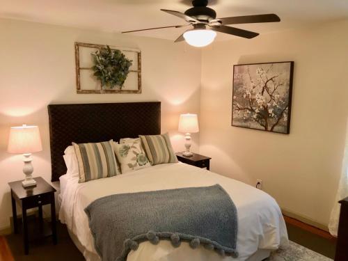 a bedroom with a bed with a ceiling fan at The Little Italy of Niagara Falls Bed & Breakfast in Niagara Falls