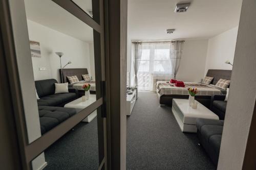 a living room with a couch and a bed and a living room at Apartmán 15 MyMara in Bešeňová