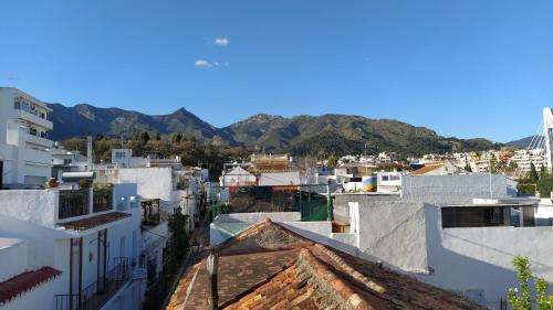 a view of a city with mountains in the background at Hostal El Gallo in Marbella