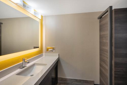 a bathroom with a sink and a mirror at Baymont by Wyndham Murfreesboro in Murfreesboro