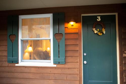 una casa con una porta verde e una finestra di The Chimney Rock Inn & Cottages a Chimney Rock