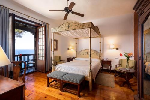 a bedroom with a canopy bed and a balcony at Parador de La Gomera in San Sebastián de la Gomera