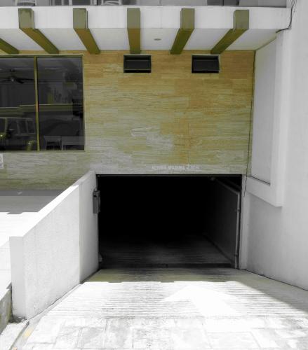 a tunnel in the side of a building at Palmarena Rooms & Residences - Long Stay Comfort with Parking, Sauna, Gym & Pool - Steps from 5th Avenue in Playa del Carmen