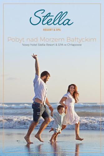 a poster of a family playing on the beach at STELLA Resort & SPA in Władysławowo