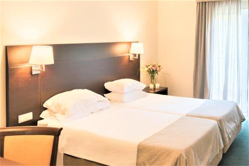 Postel nebo postele na pokoji v ubytování Amazonia Jamor Hotel