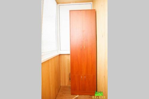 a wooden door in a room with a window at Героев Днепра 53, рядом пляж in Cherkasy