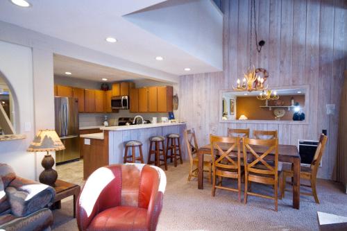 a kitchen and living room with a table and chairs at Mammoth Ski & Racquet Club #86 in Mammoth Lakes