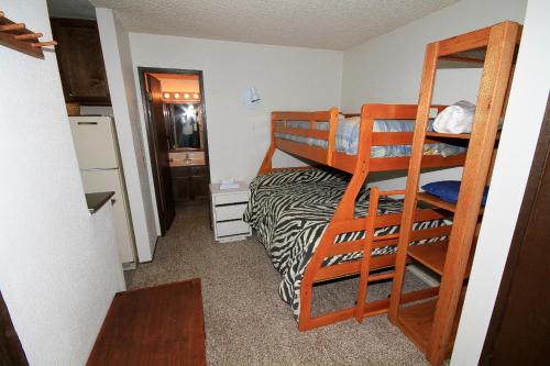 a small room with a bunk bed and a ladder at Crestview #17 in Mammoth Lakes