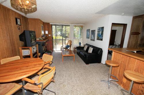 a living room with a table and a couch at Crestview #17 in Mammoth Lakes