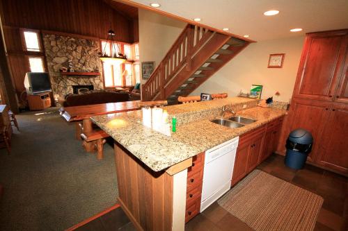 a kitchen with a sink and a staircase at Mountainback #63, Loft, Den in Mammoth Lakes