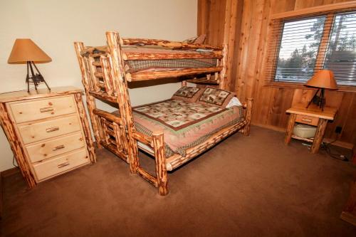 a bedroom with a bunk bed and a night stand at Mountainback #52, Loft, Corner in Mammoth Lakes