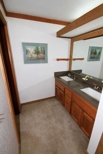 a bathroom with two sinks and a mirror at Mountainback 72 Corner Unit in Mammoth Lakes