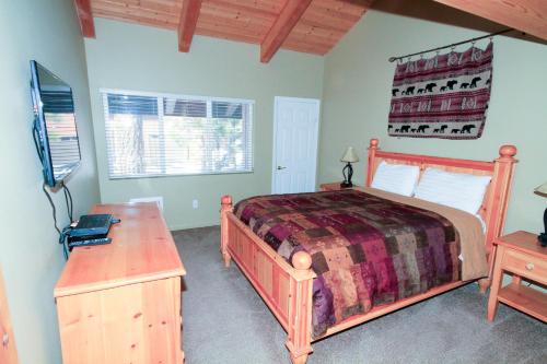 a bedroom with a bed and a desk and a television at Mammoth Ski & Racquet Club #70 in Mammoth Lakes
