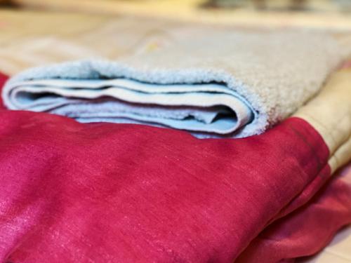 a pile of towels sitting on top of a bed at Agroturystyka Siołki in Siodłkowice