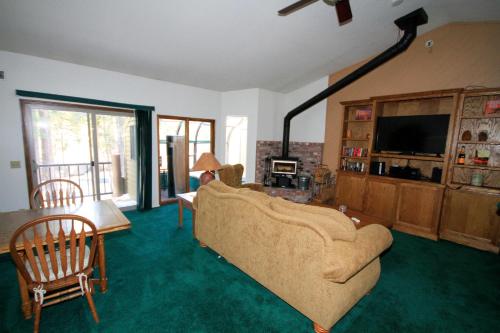 a living room with a couch and a tv at Forest Creek #3, Pet accepted in Mammoth Lakes