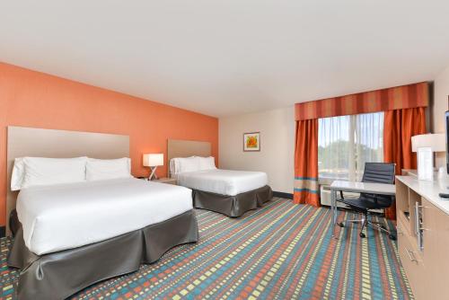 a hotel room with two beds and a desk at Holiday Inn Express Albuquerque N - Bernalillo, an IHG Hotel in Bernalillo