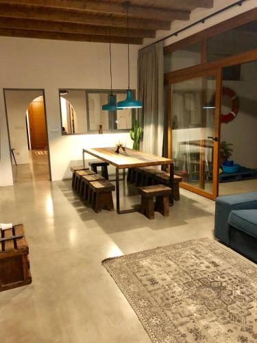 a living room with a table and a blue couch at VILLA RELAX, LA GRACIOSA in Caleta de Sebo