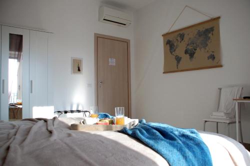 a bedroom with a bed with a blue blanket on it at Dimore del Sud in Trani