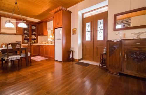 a kitchen and dining room with a table and a refrigerator at "En Hatipi" in Sparti