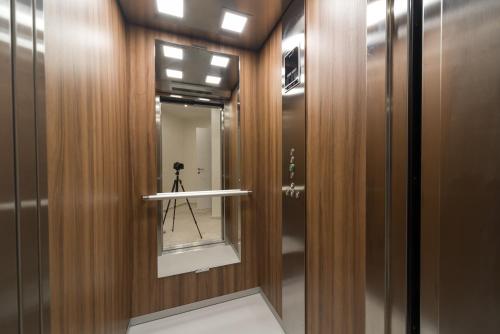 a camera on a tripod in a hallway with a mirror at Villa Solaria in Sveti Stefan