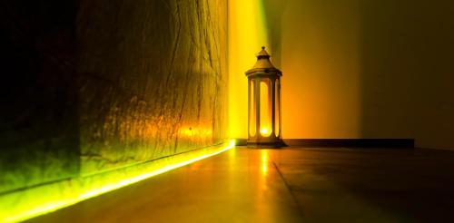 a lit up street light next to a wall at Habitat Hotel in Kilkís