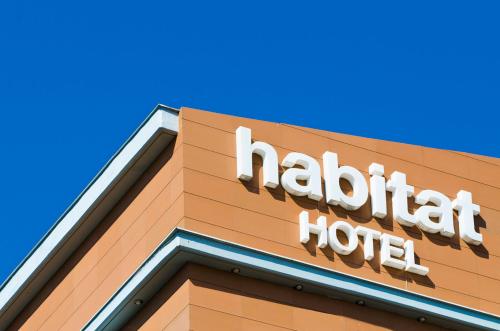 a hotel sign on the side of a building at Habitat Hotel in Kilkís