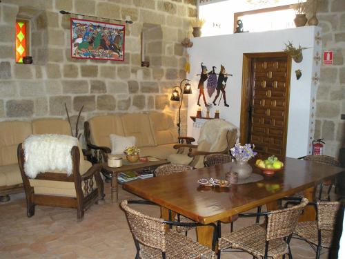 a living room with a table and chairs at TORRE FUERTE Siglo XIII in Baños de Rioja