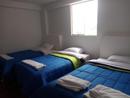 מיטה או מיטות בחדר ב-Marvelous Hostel Cusco