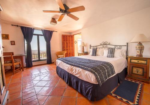a bedroom with a bed and a ceiling fan at Casa Estrella de la Valenciana Hotel Boutique in Guanajuato