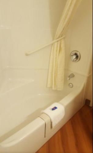 a bathroom with a bath tub with a towel at Motel 6-Roseburg, OR in Roseburg