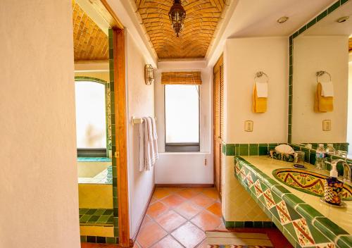 a bathroom with a large sink and a shower at Casa Estrella de la Valenciana Hotel Boutique in Guanajuato