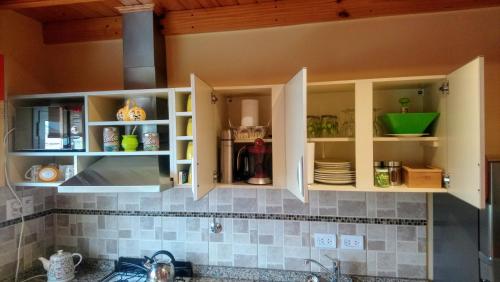 a kitchen with white cabinets and a sink at El Buen Descanso in Río Gallegos