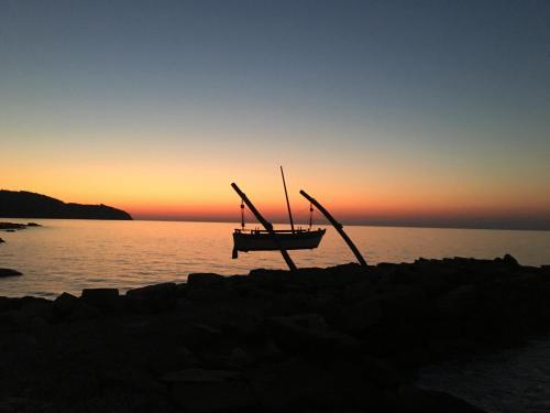 a boat sitting on the beach at sunset at Fontana in Izola