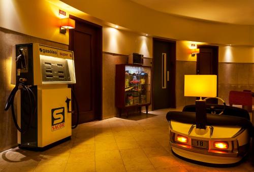 a hotel room with a pay phone in a room at Pao de Acucar Hotel in Porto