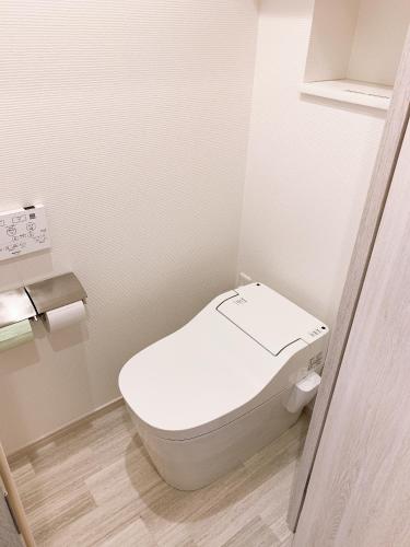 a small bathroom with a toilet in a room at Purpose Resort Ocean View Kamakura in Kamakura