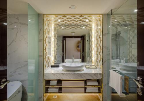 a bathroom with a sink and a mirror at NagaWorld Hotel & Entertainment Complex in Phnom Penh