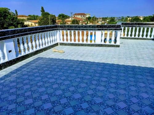 a blue tile floor on a balcony with a white railing at The Winford Boutique Hotel Achimota in Accra