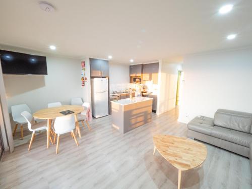 a kitchen and living room with a table and a couch at Wallaroo Holiday Park in Wallaroo