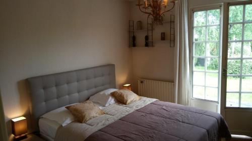 a bedroom with a bed with two pillows on it at Les Gites Lussacois in Lussac-les-Châteaux
