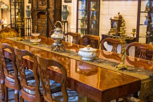 a long wooden table with wooden chairs and a table at Lansheng yard in Xiamen