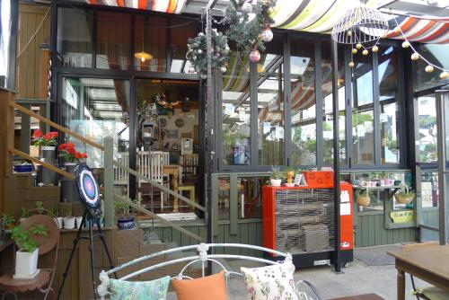 a store front with a lot of windows and a bench at The House Hostel in Sokcho