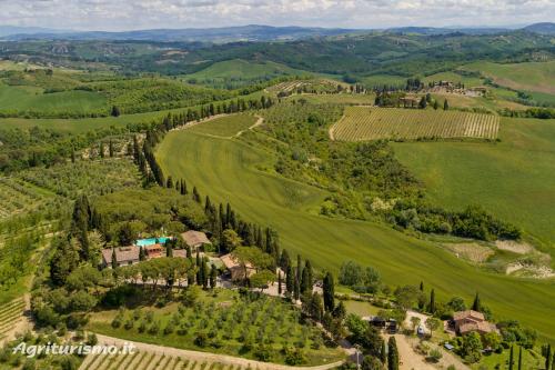 an aerial view of a farm in the hills at Agriturismo Pieve Sprenna in Buonconvento