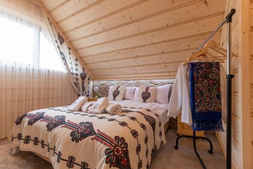 a bedroom with a bed in a wooden house at Domki Pod Jemiołą in Zakopane