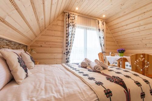 a bedroom with a bed in a room with a window at Domki Pod Jemiołą in Zakopane